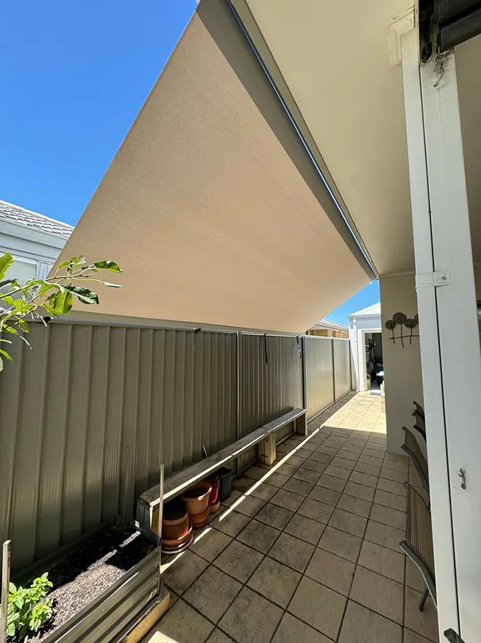 Roof to fence blinds Perth providing shade and privacy along a side passage