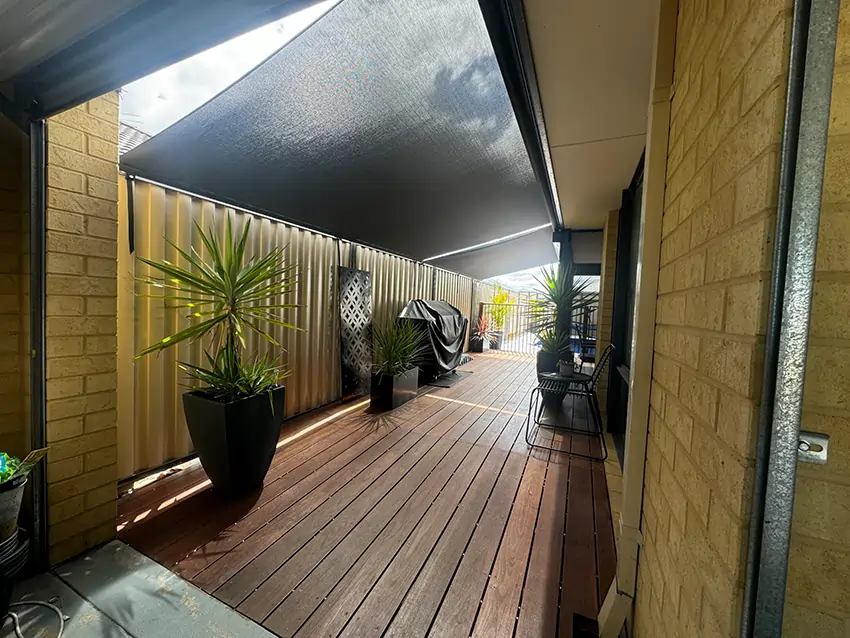 Perth roof-to-fence screens shading a narrow timber deck — Outdoor Shades WA