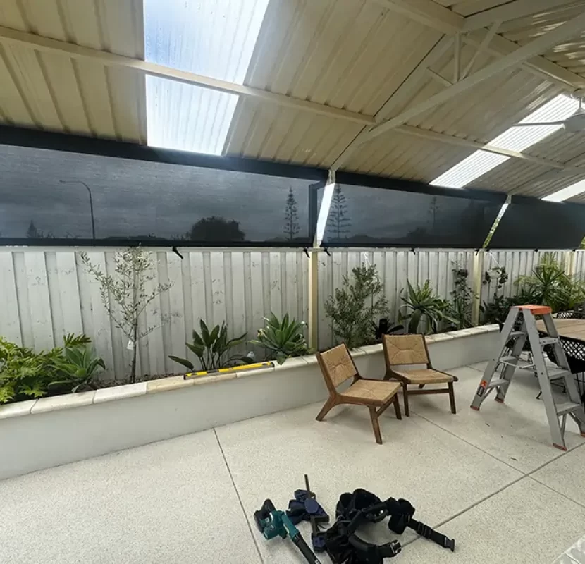Outdoor Shades WA roofline-to-fence mesh blinds in a Perth alfresco