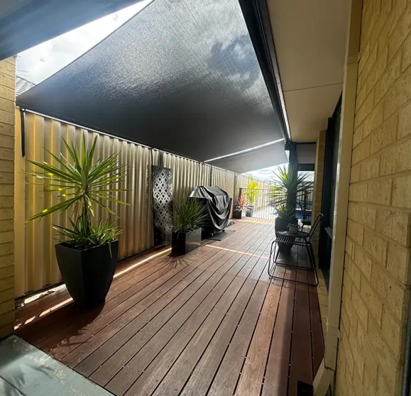 Perth roof-to-fence screens shading a narrow timber deck — Outdoor Shades WA