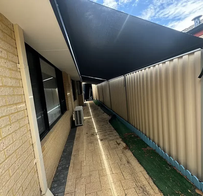 Outdoor Shades WA roof-to-fence blinds shading a long side walkway in Perth