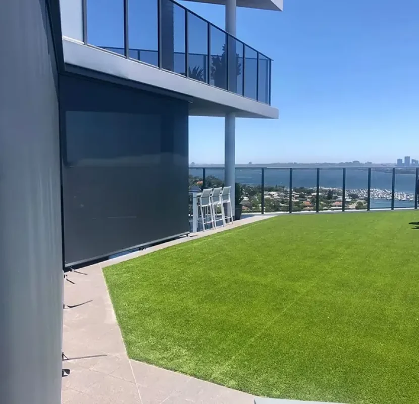 Straight drop blinds Perth installed in an Applecross home to provide shade and privacy on a balcony with river views